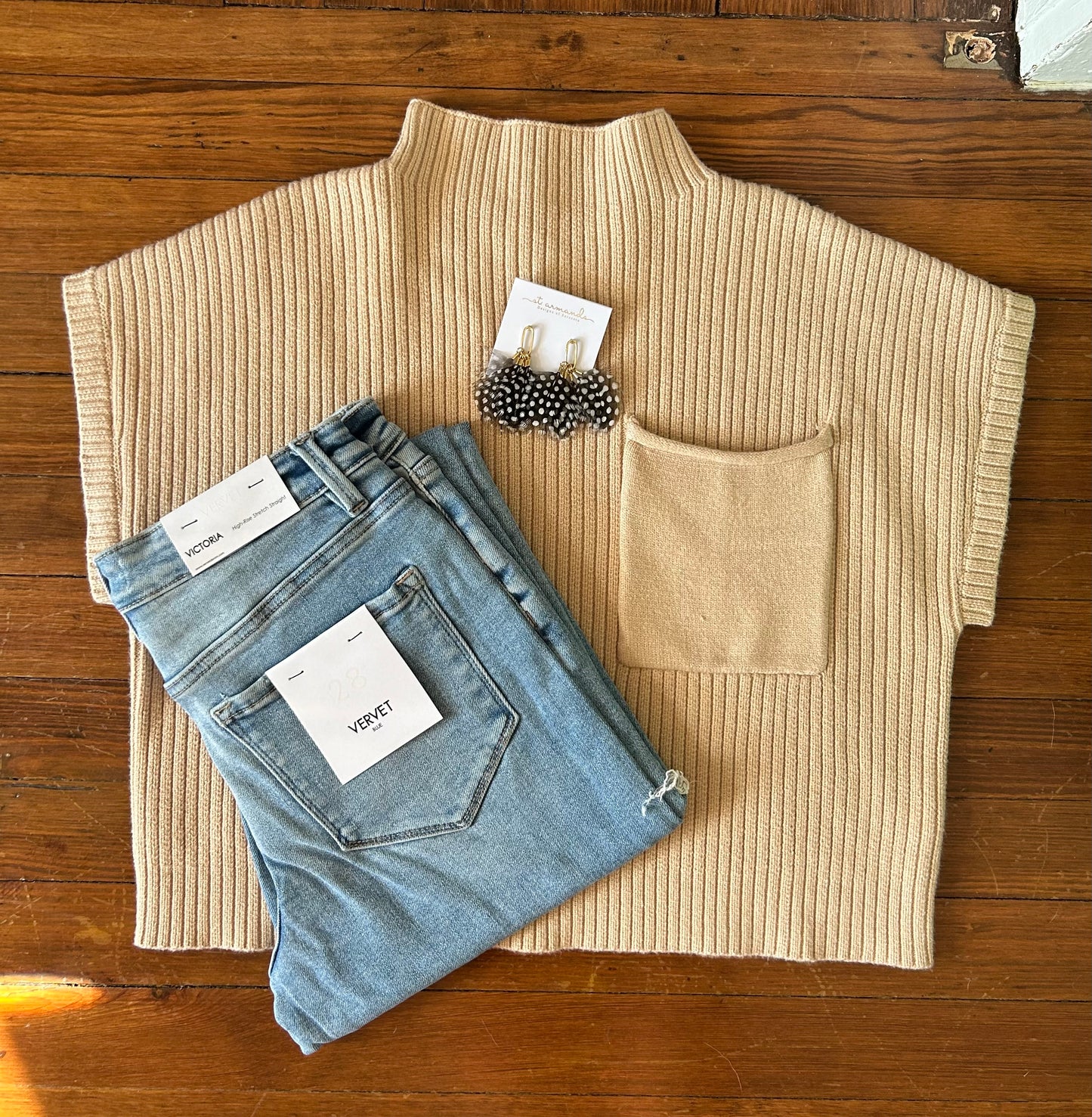 Mock neck sweater in a neutral bone color with front pocket.