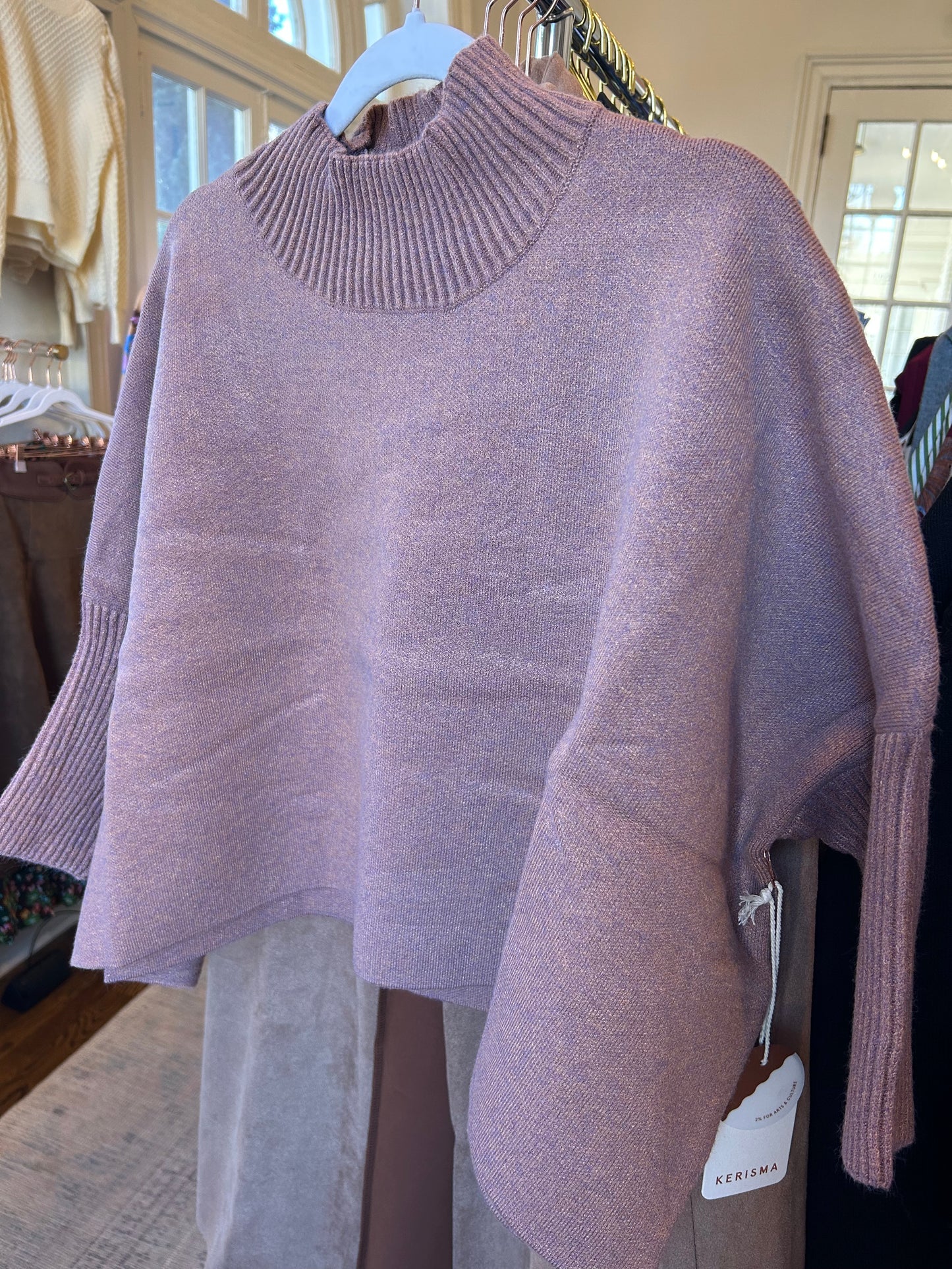 Dusty Rose sweater on a hanger