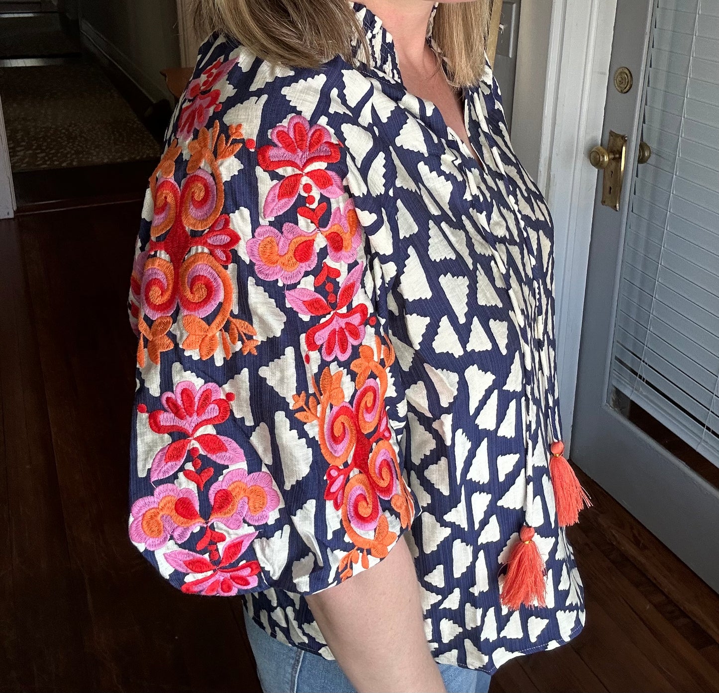 Embroidered puff sleeve top in orange, pink and blue.