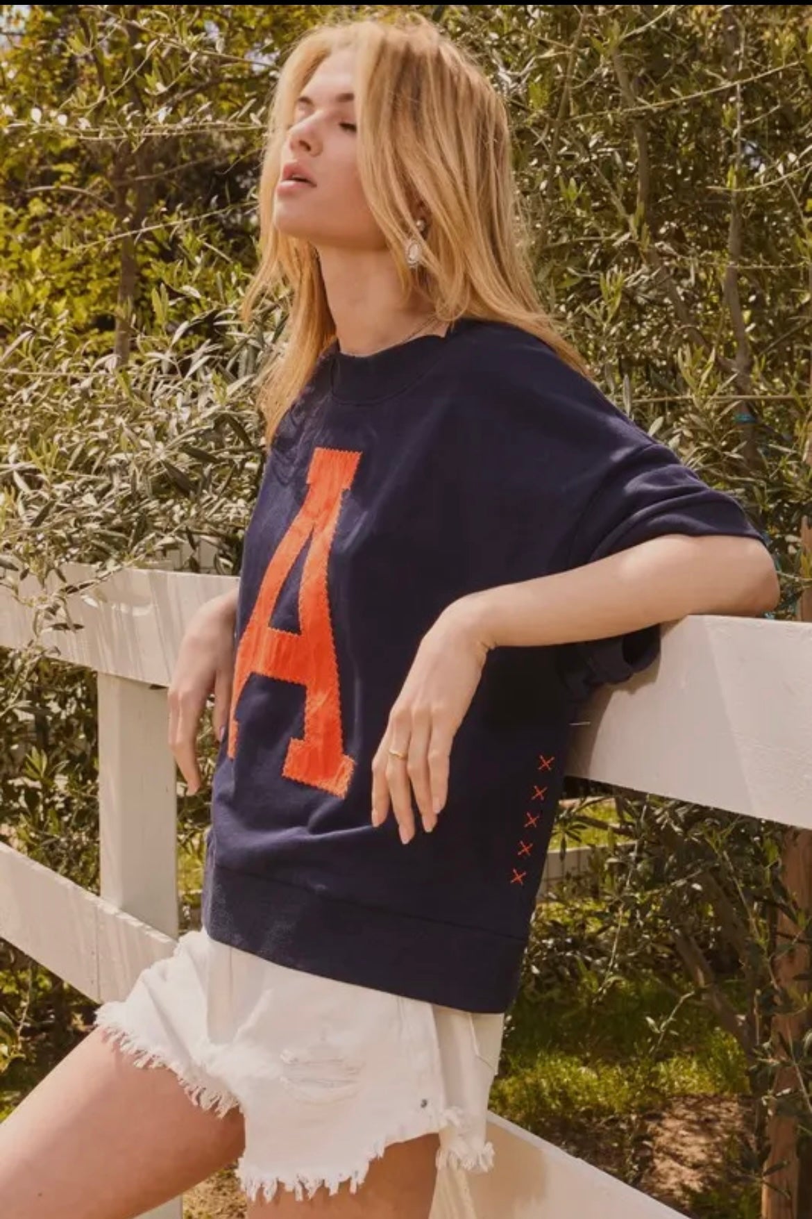 Navy short sleeve sweatshirt with orange “A”