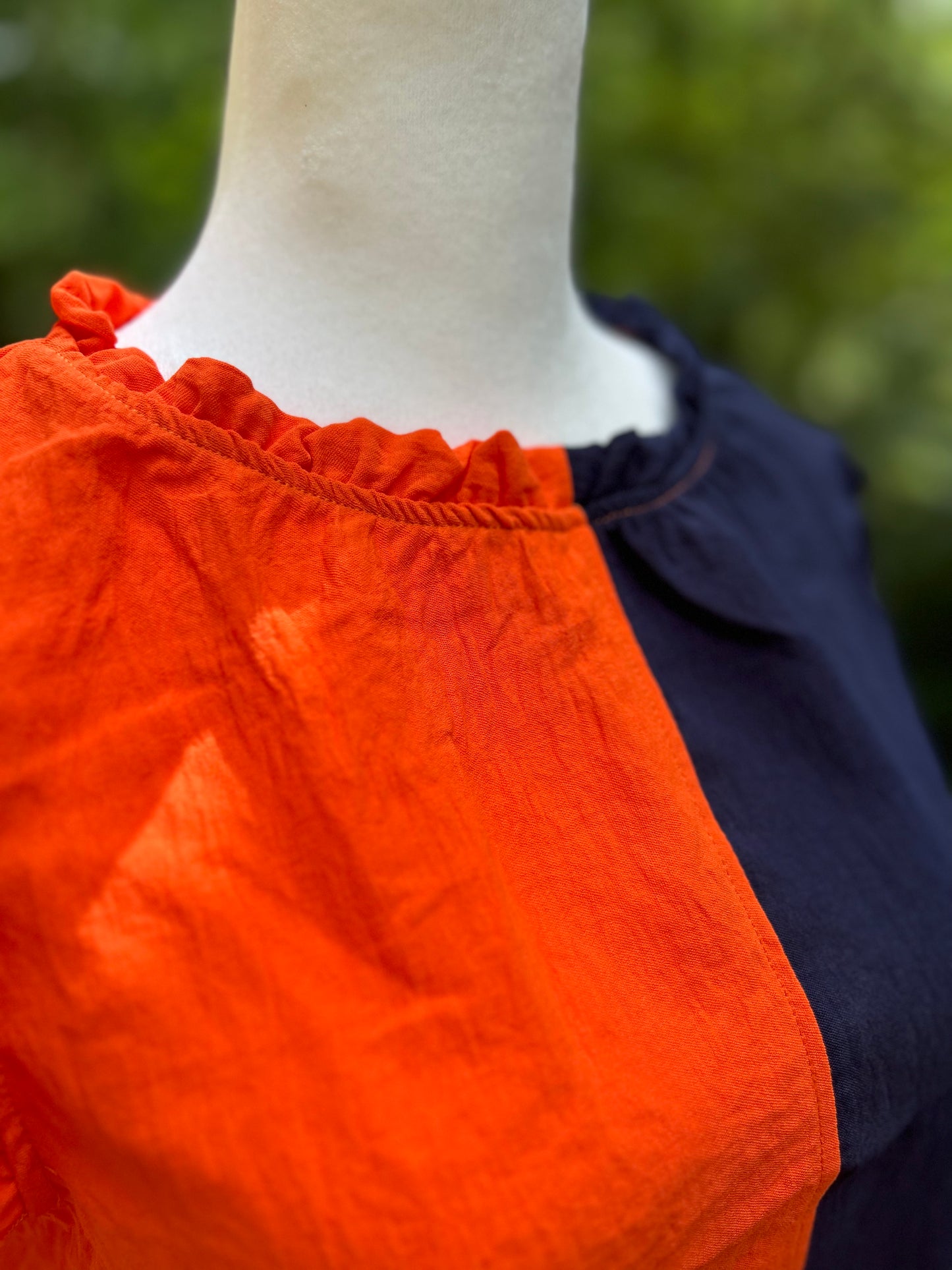 Navy and orange colorblock top with ruffle detail
