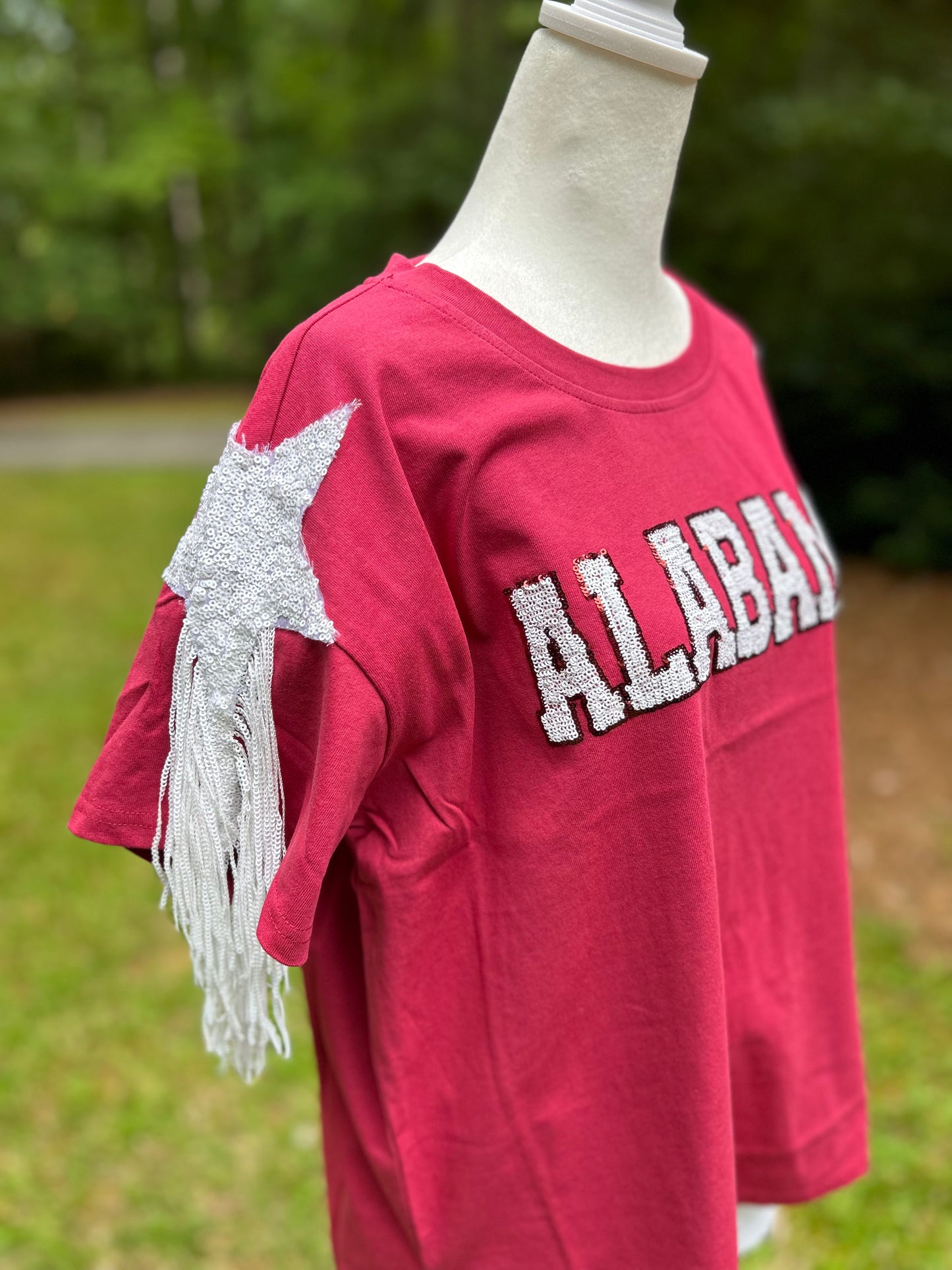 Sequin top in crimson and white. Sequin and fringe details.