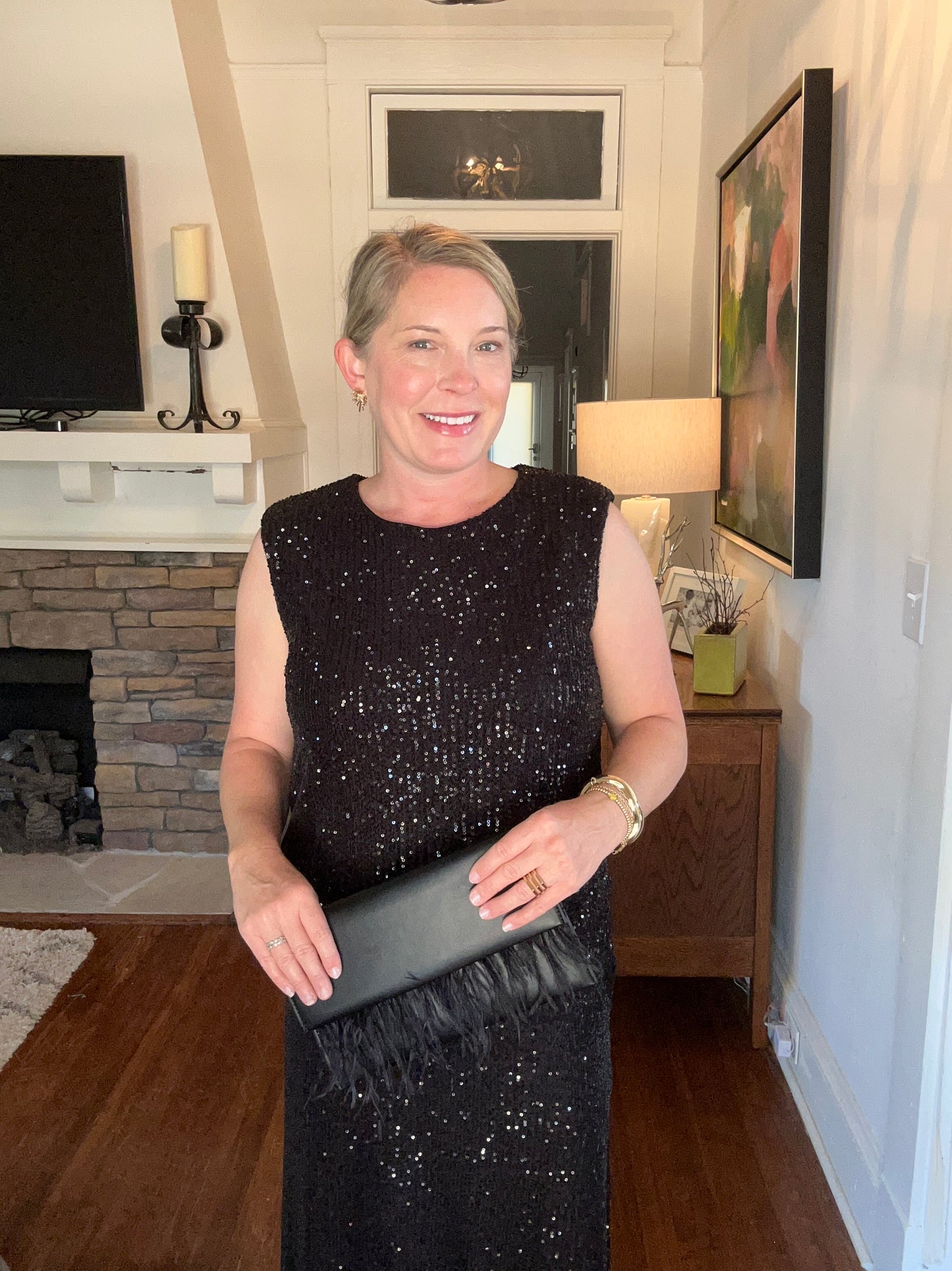 Sleeveless sequin top in black with 3/4 back zipper and padded shoulders.