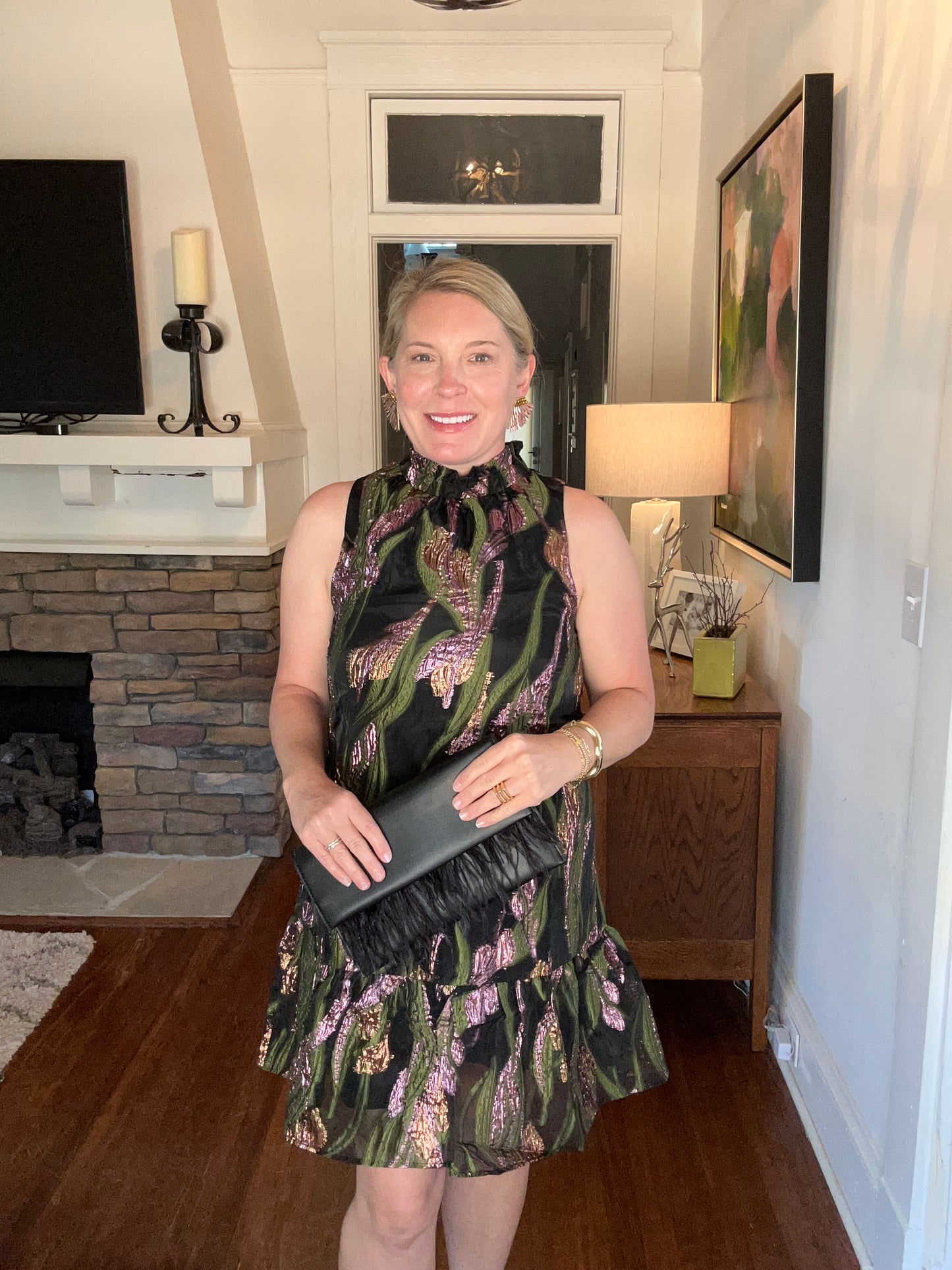 Short, sleeveless metallic dress in black, pink and green. Stretchy mock neck and ruffled bottom hem.