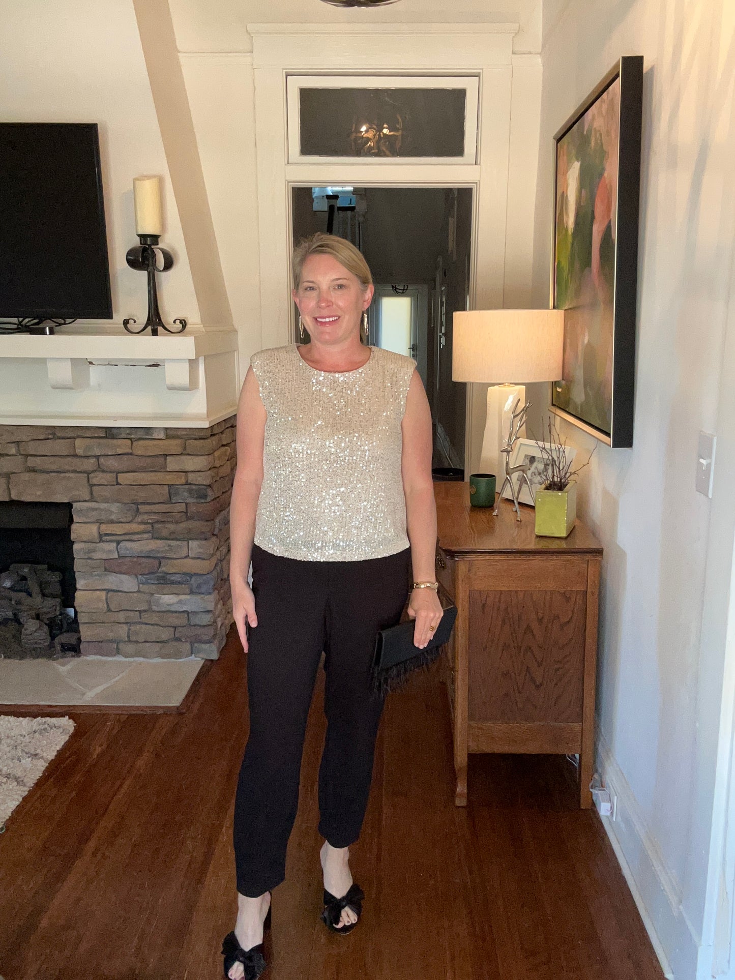 Sleeveless sequin top in champagne. 3/4 zipper in back and slightly padded shoulders.