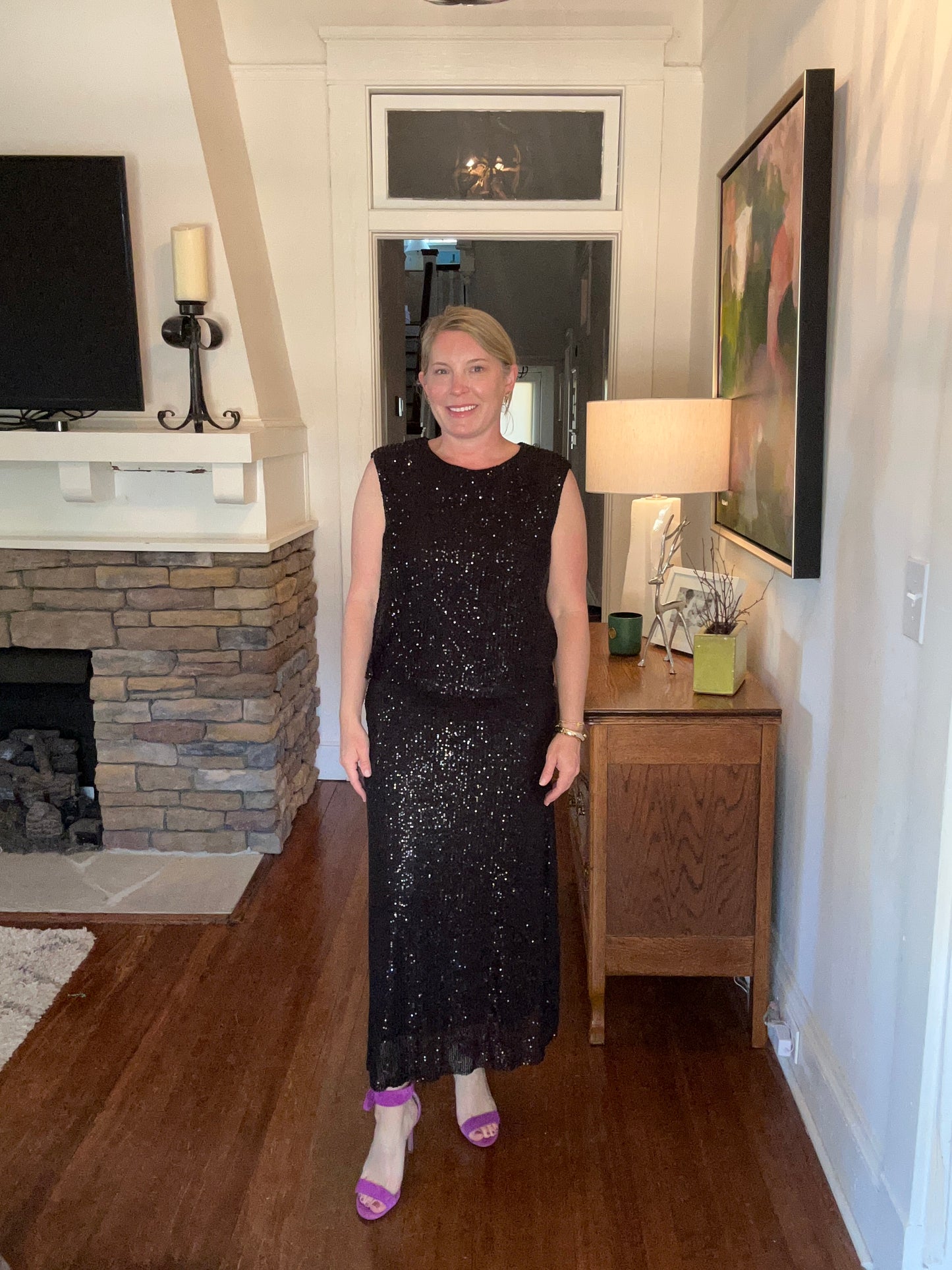 Slightly padded shoulders, black sequin sleeveless top.