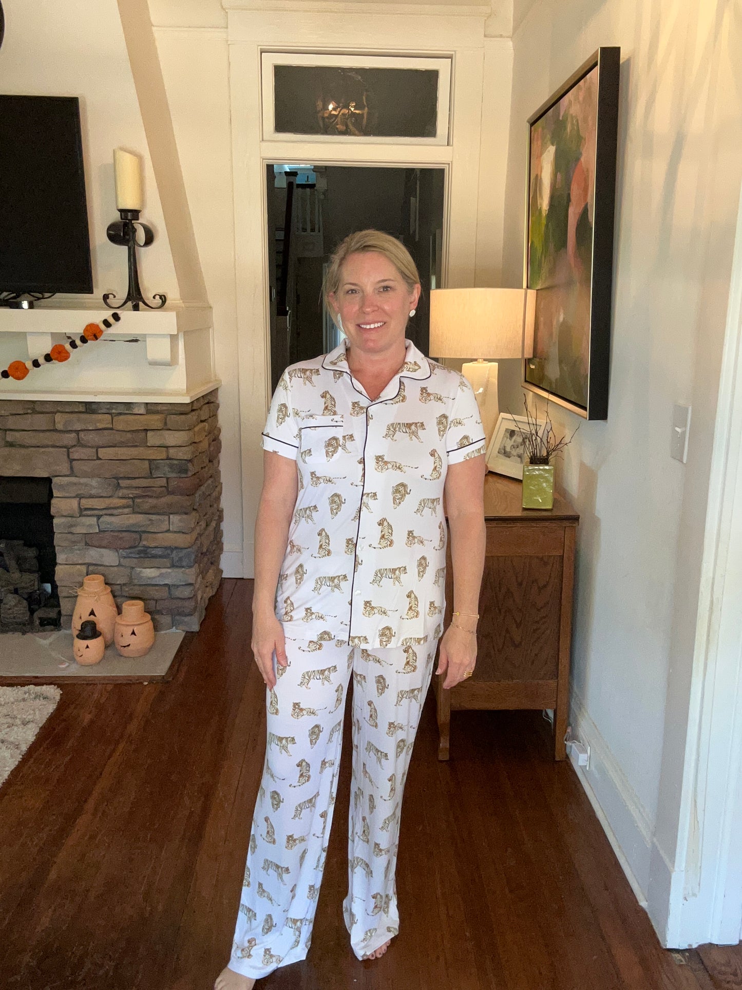 Pajama set with tigers printed on them. Button up, short sleeve top and long pants.