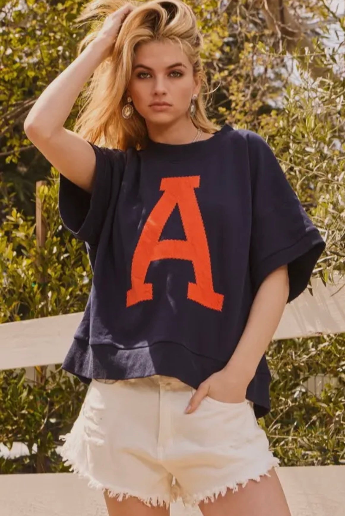 Navy short sleeve sweatshirt with orange “A”