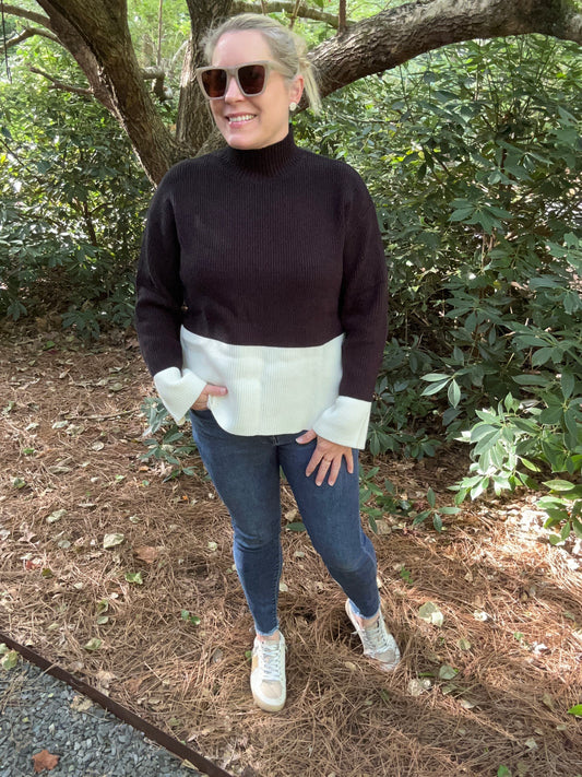 color block sweater in black and white. Mock neck and long sleeves. 