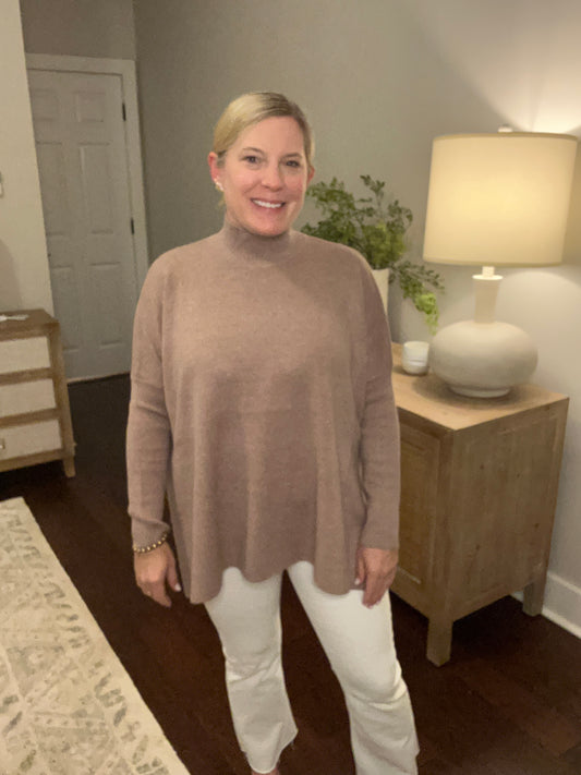 Soft, mock neck sweater. Long sleeve, solid color sweater. Side slits allows for a flowy fit. Comes in mocha, black and plum. 