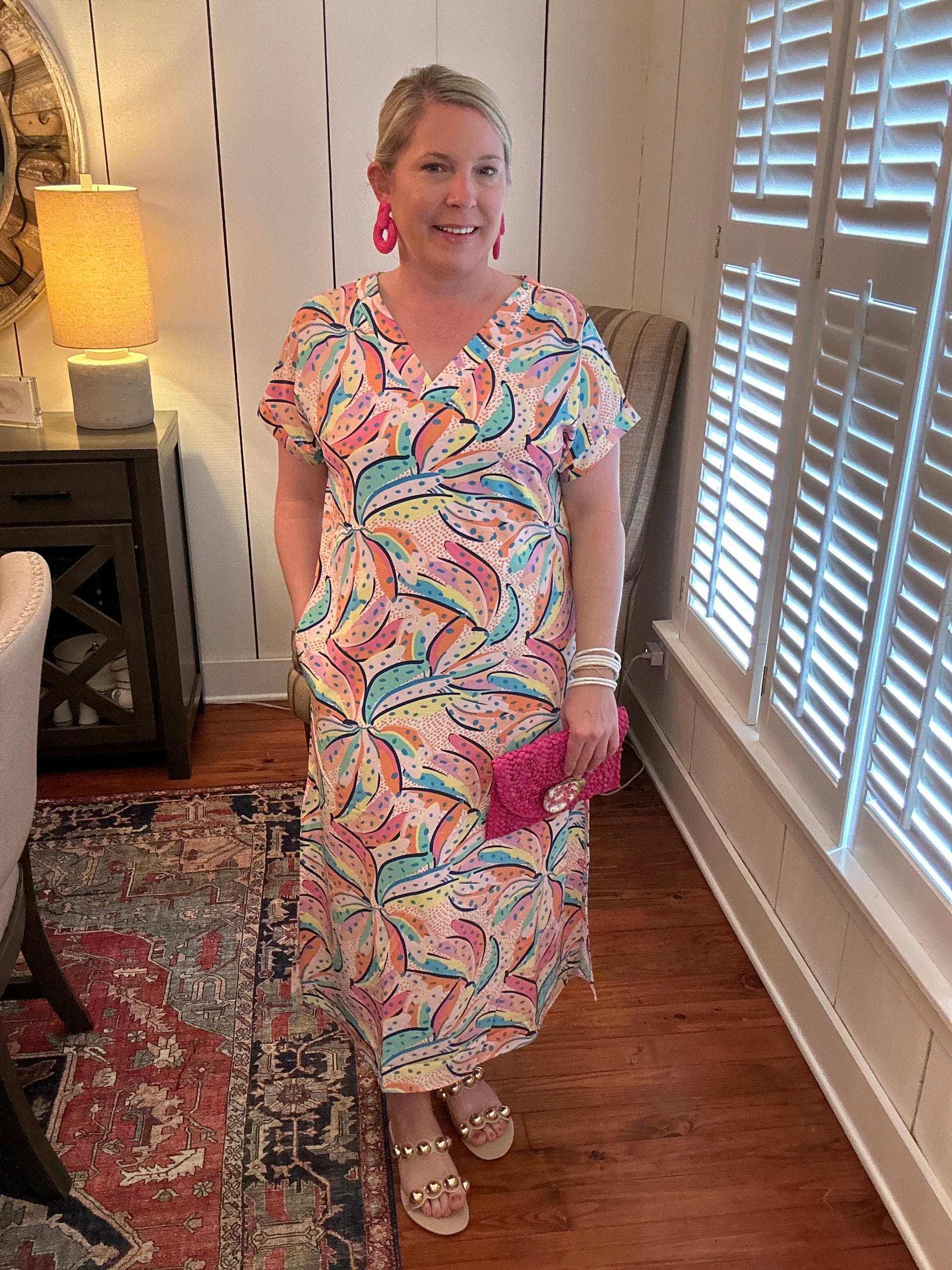 V-eck, midi dress. Abstract banana print all over with pinks, blues, yellows, and purples. Small dots all over also. Pullover flowy style with pockets!