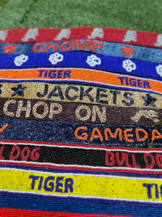 Beaded gameday straps you can add to your stadium bags. In multiple colors for college teams.