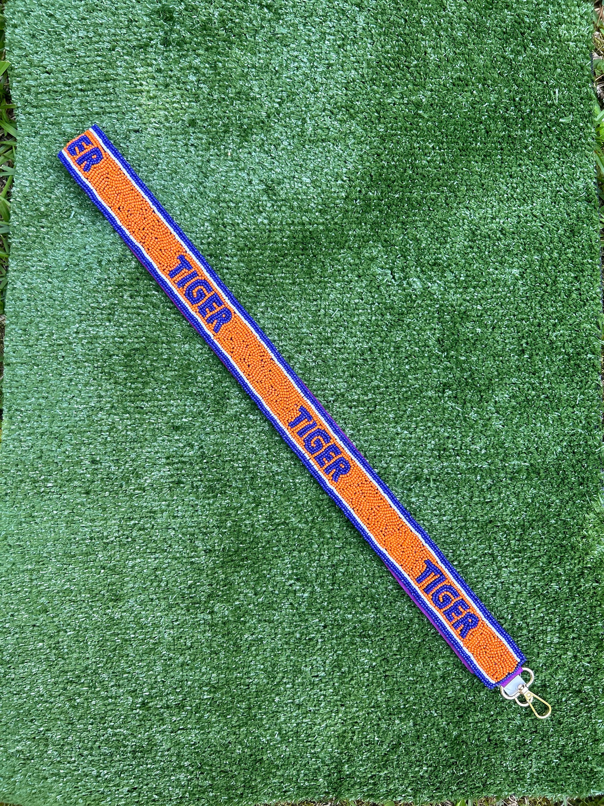 Beaded gameday strap for stadium bag. Orange and purple spelling out Tiger. 