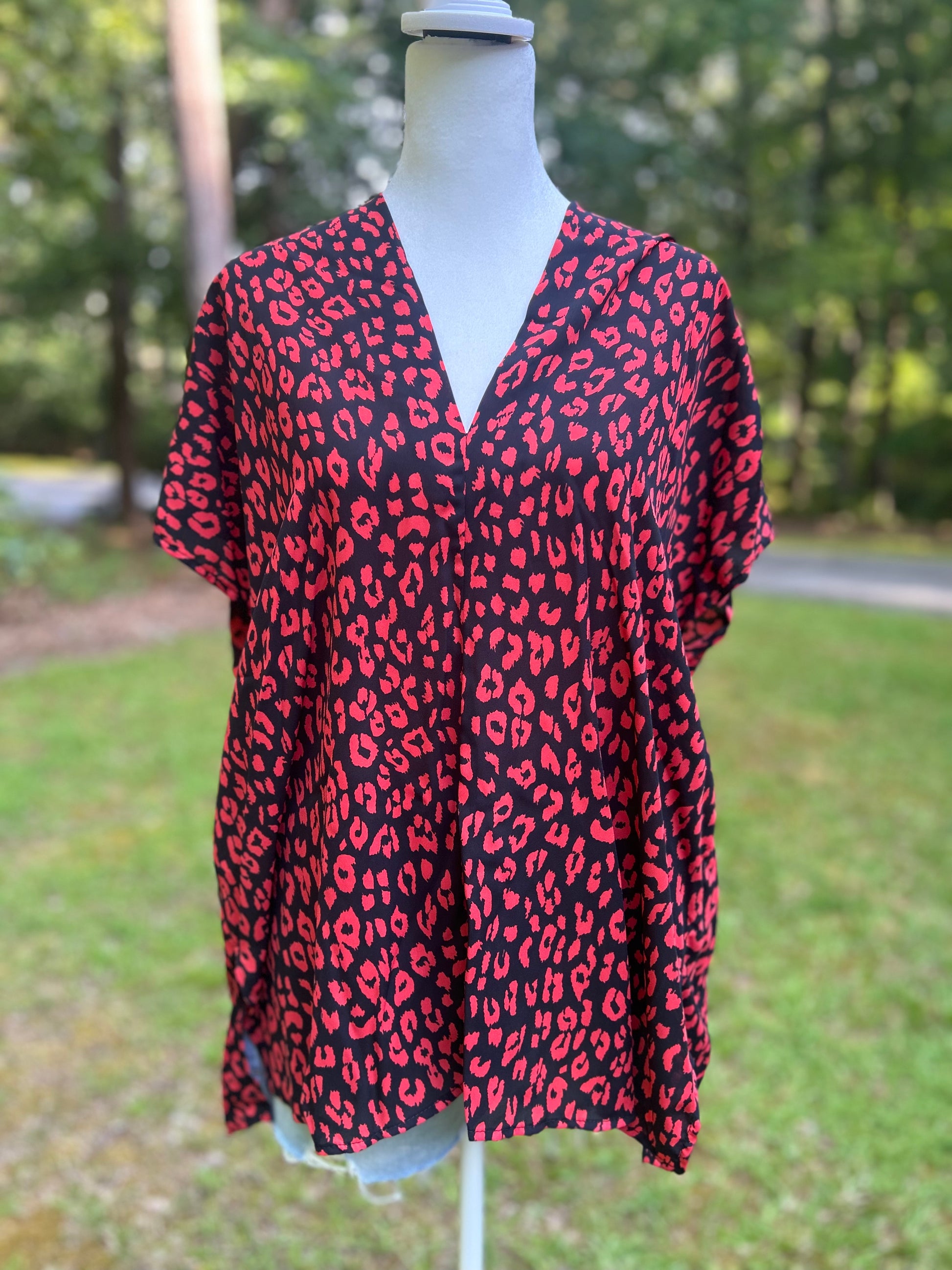 v-neck top with black and red leopard print. 