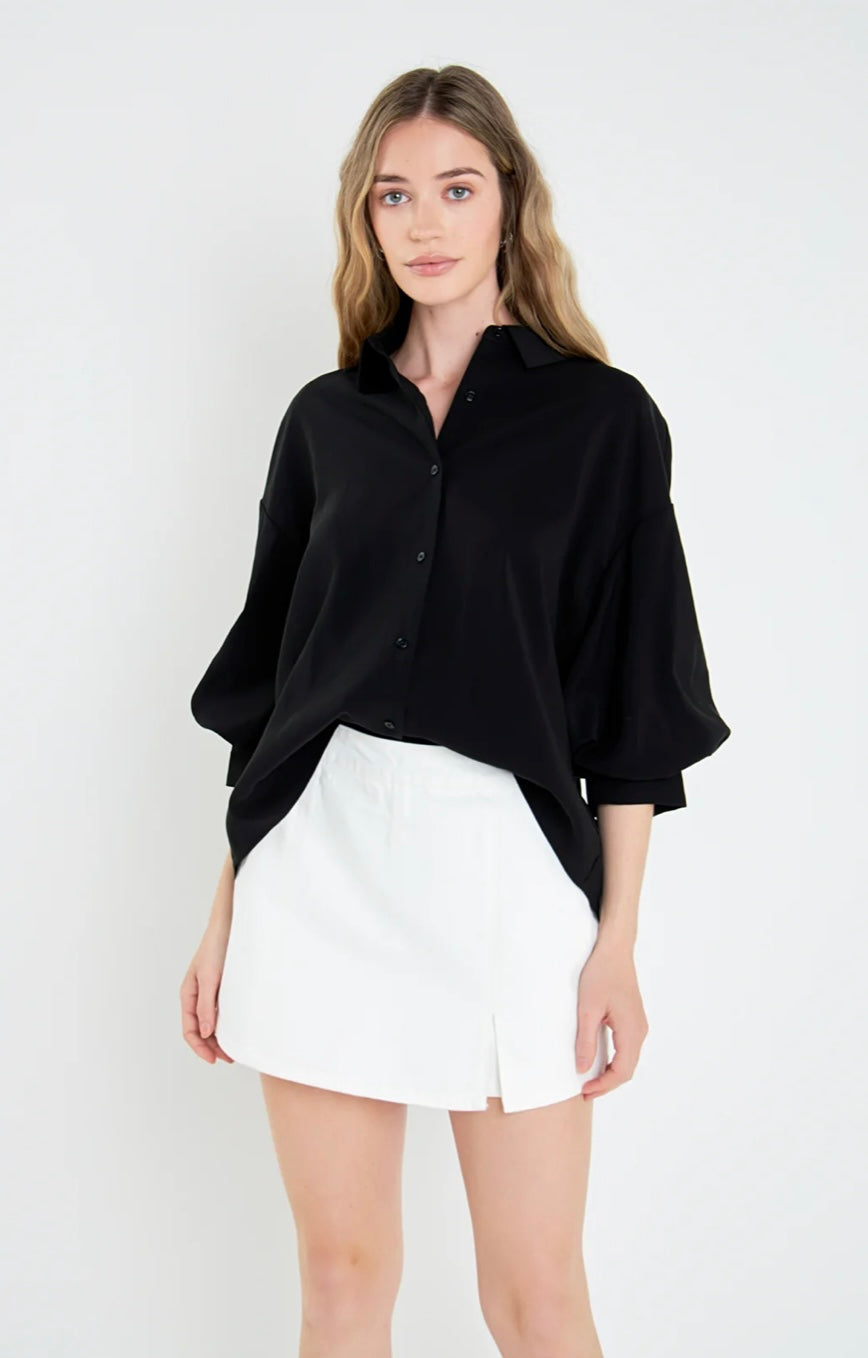 Black button up blouse with balloon sleeves and a button cuff.