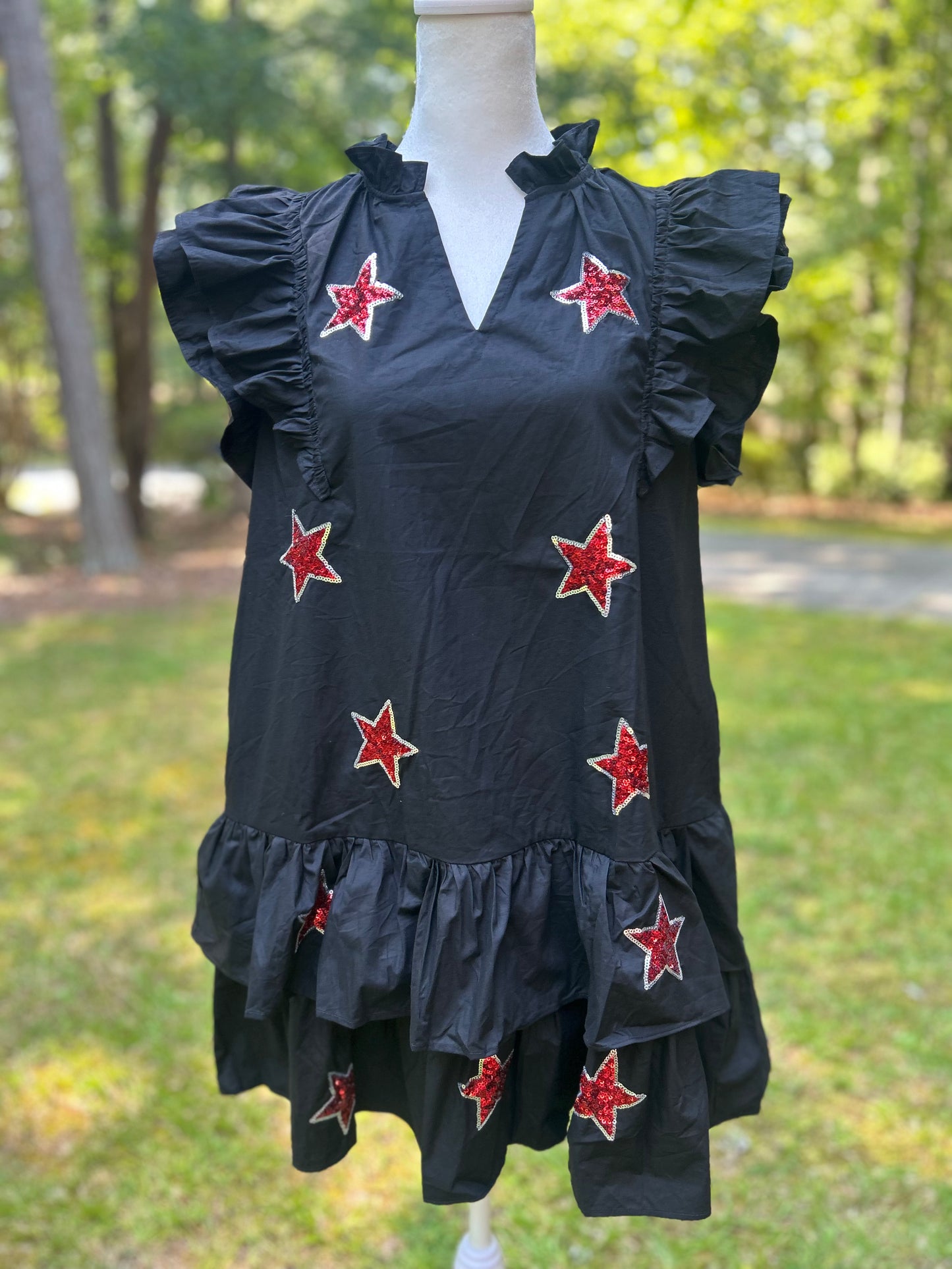 Black ruffle dress with red sequin stars.