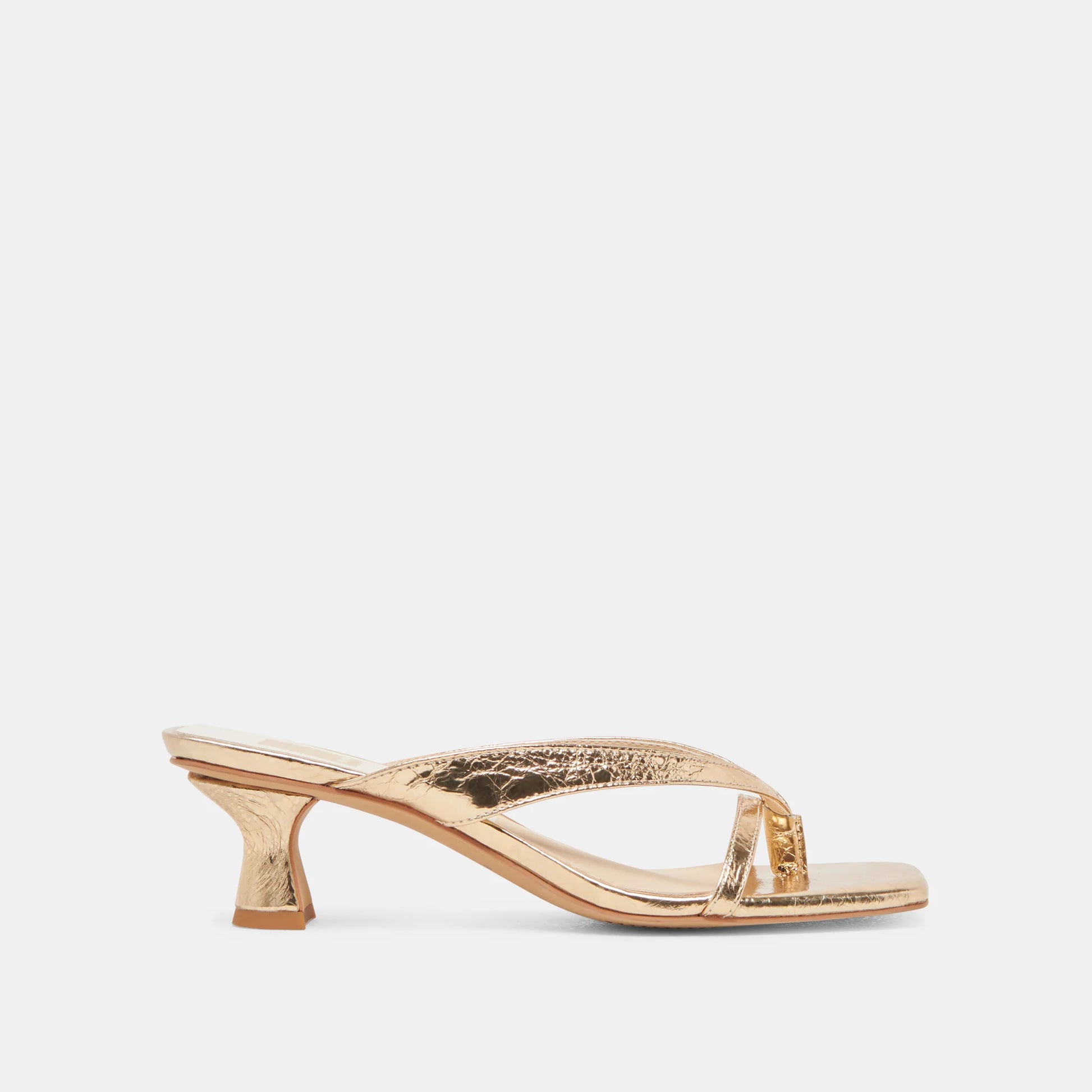 Gold high-heeled sandal on a white background