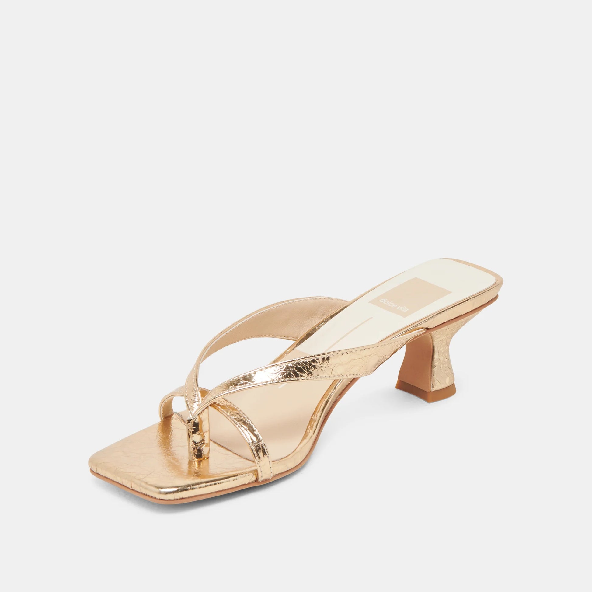 Gold high-heeled sandal on a white background