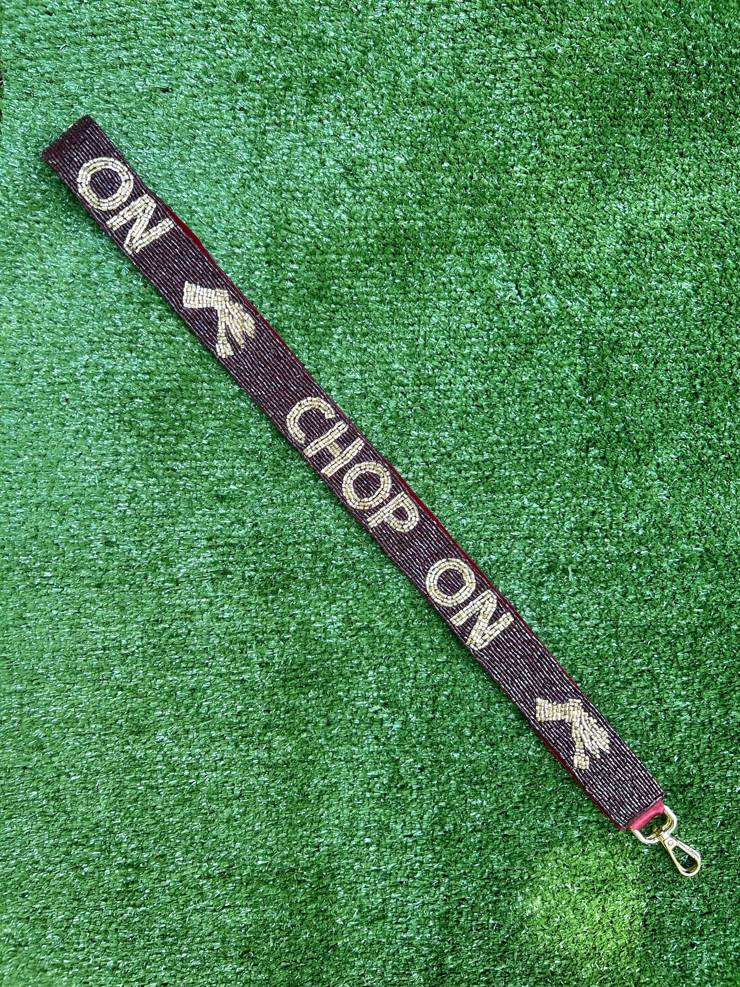 Beaded gameday strap for Florida State. Garnet background with gold letters spelling out Chop On. 