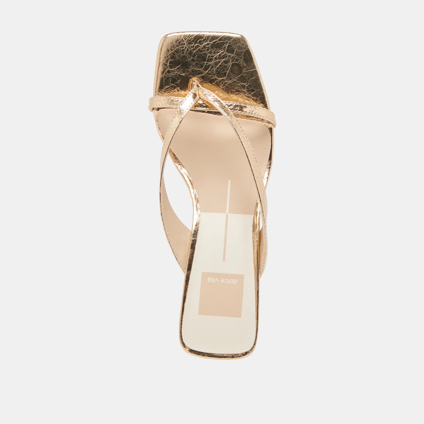 Gold high-heeled sandal on a light gray background