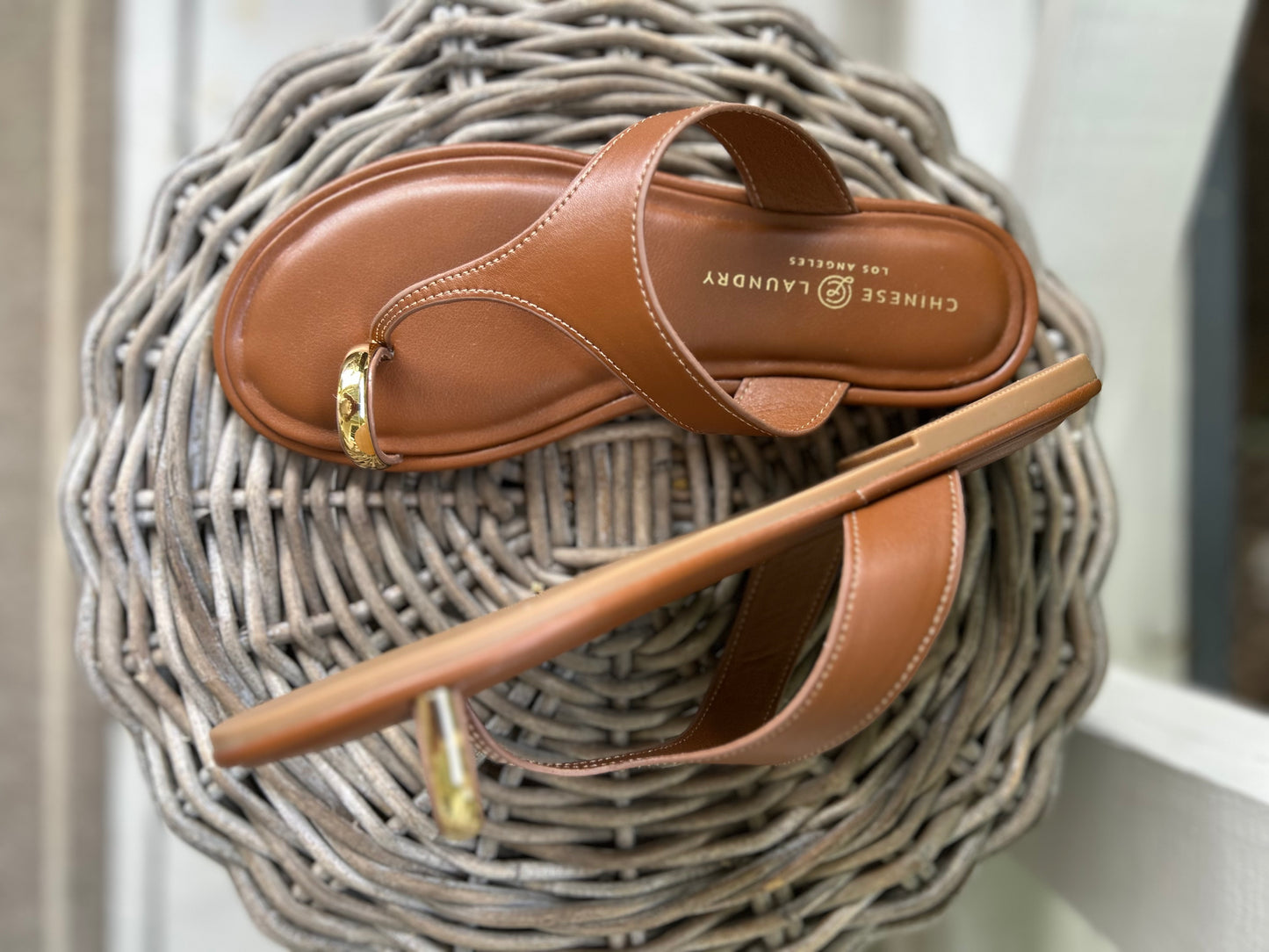 Flat sandals with a gold toe strap by Chinese Laundry 