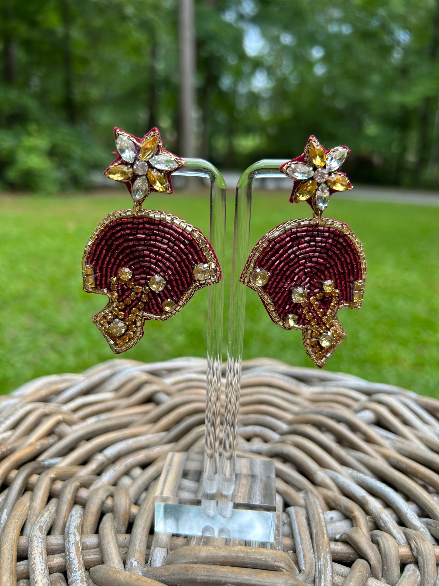 Lightweight, beaded earrings in garnet and gold football helmets. 