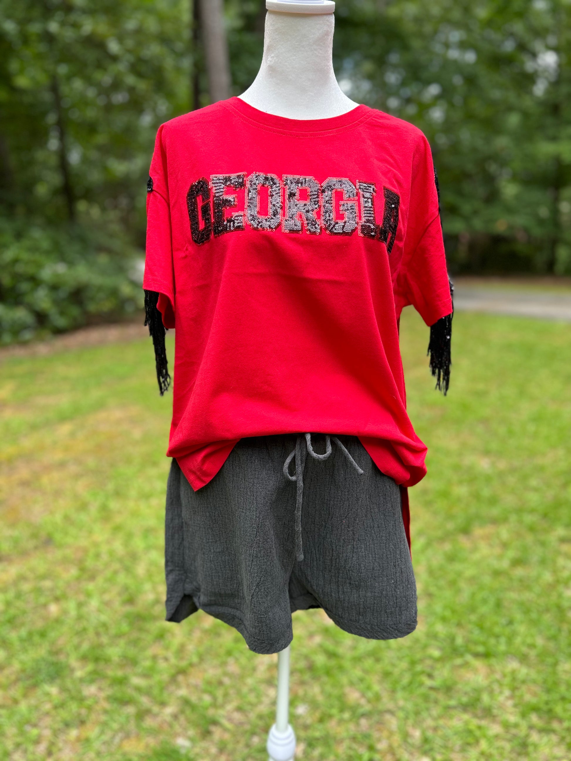 Red shirt with black sequin letters spelling out Georgia, Sequin fringe detail on the sleeves