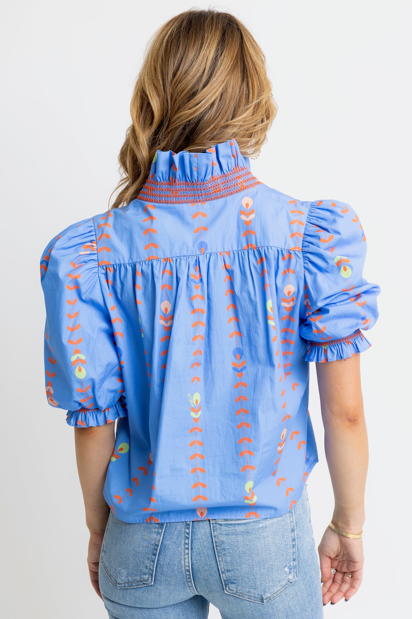 Floral top with ruffled sleeves and collar in periwinkle. 