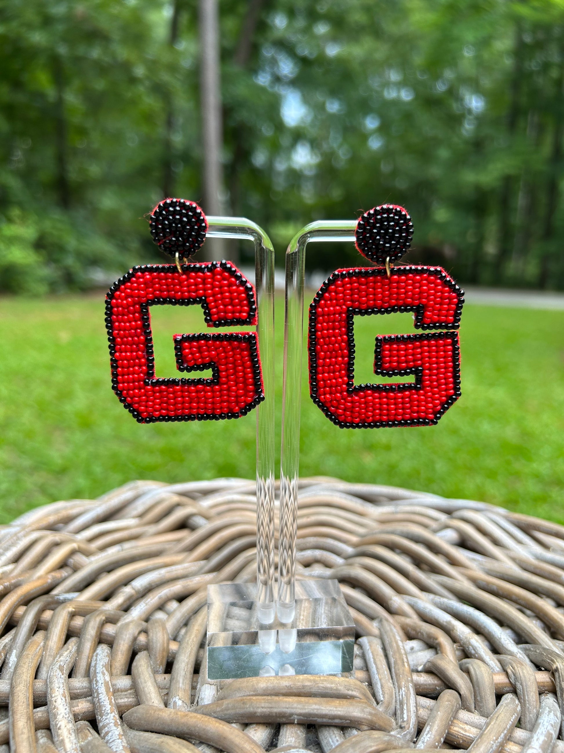 Lightweight, "G" beaded earrings in red with a black border and black beaded stud part. 