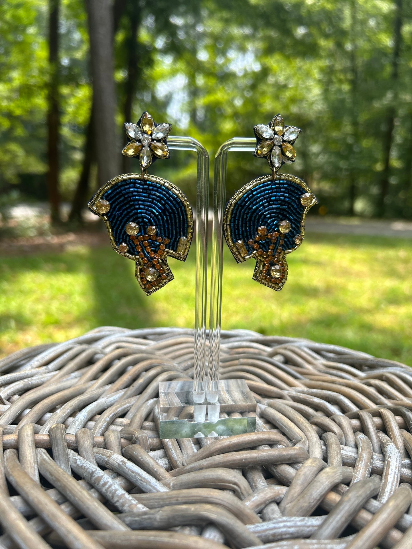 Lightweight, beaded footnall helmet earrings in navy with a gold border detail. 