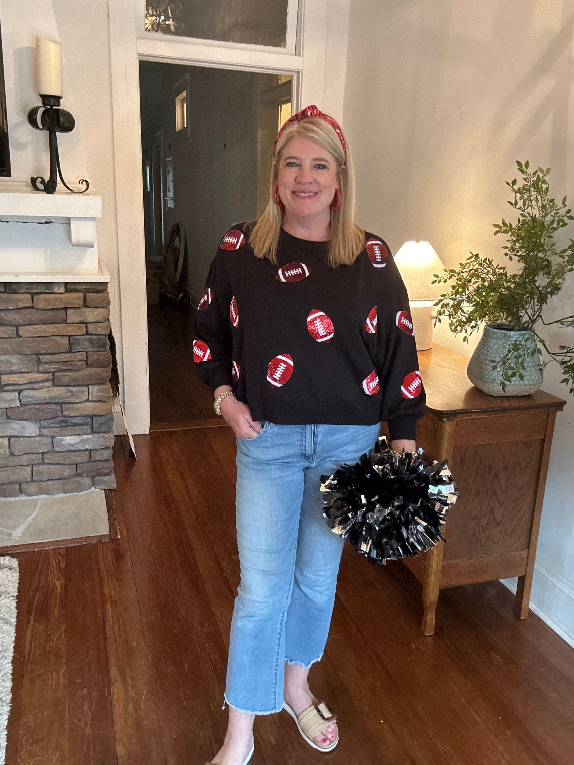 Black sweatshirt with red and white sequin footballs