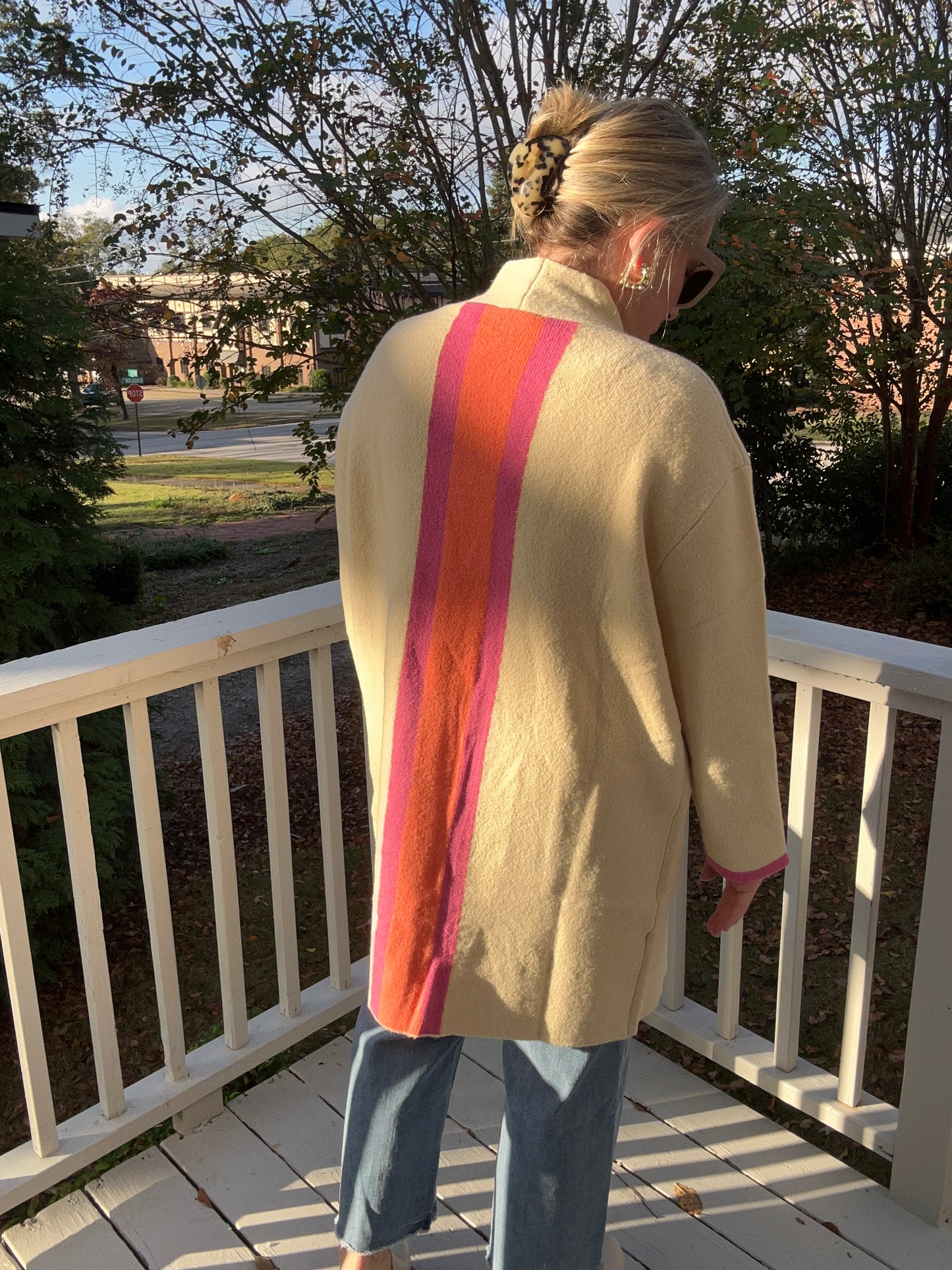 Cream midi cardigan with stripe detail on the back in orange and pink. 