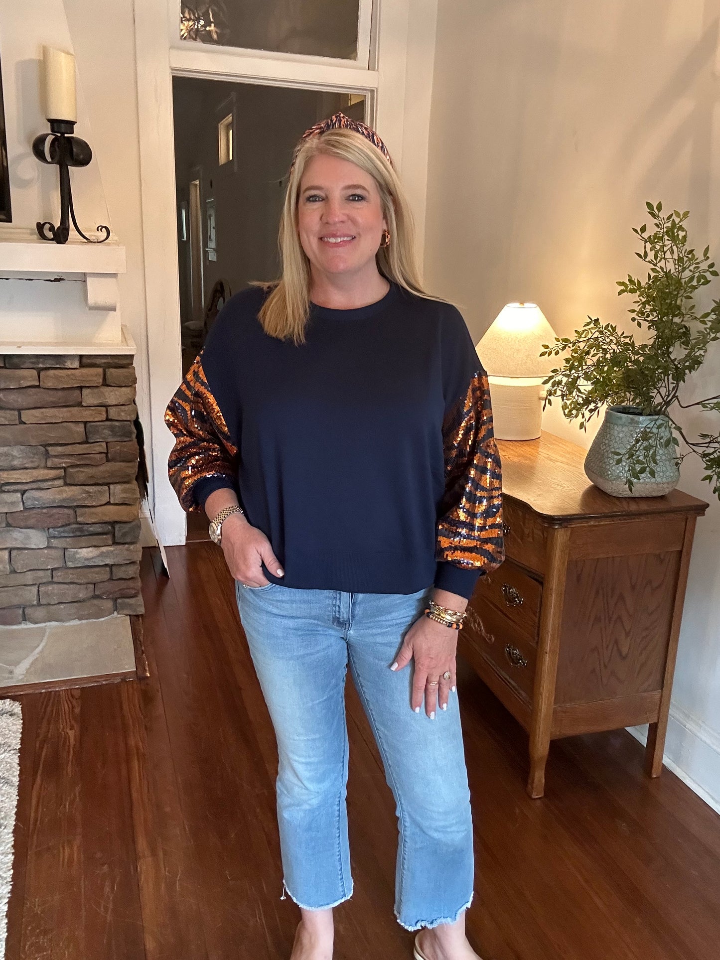 Navy sweatshirt with sequin sleeves in orange tiger stripes