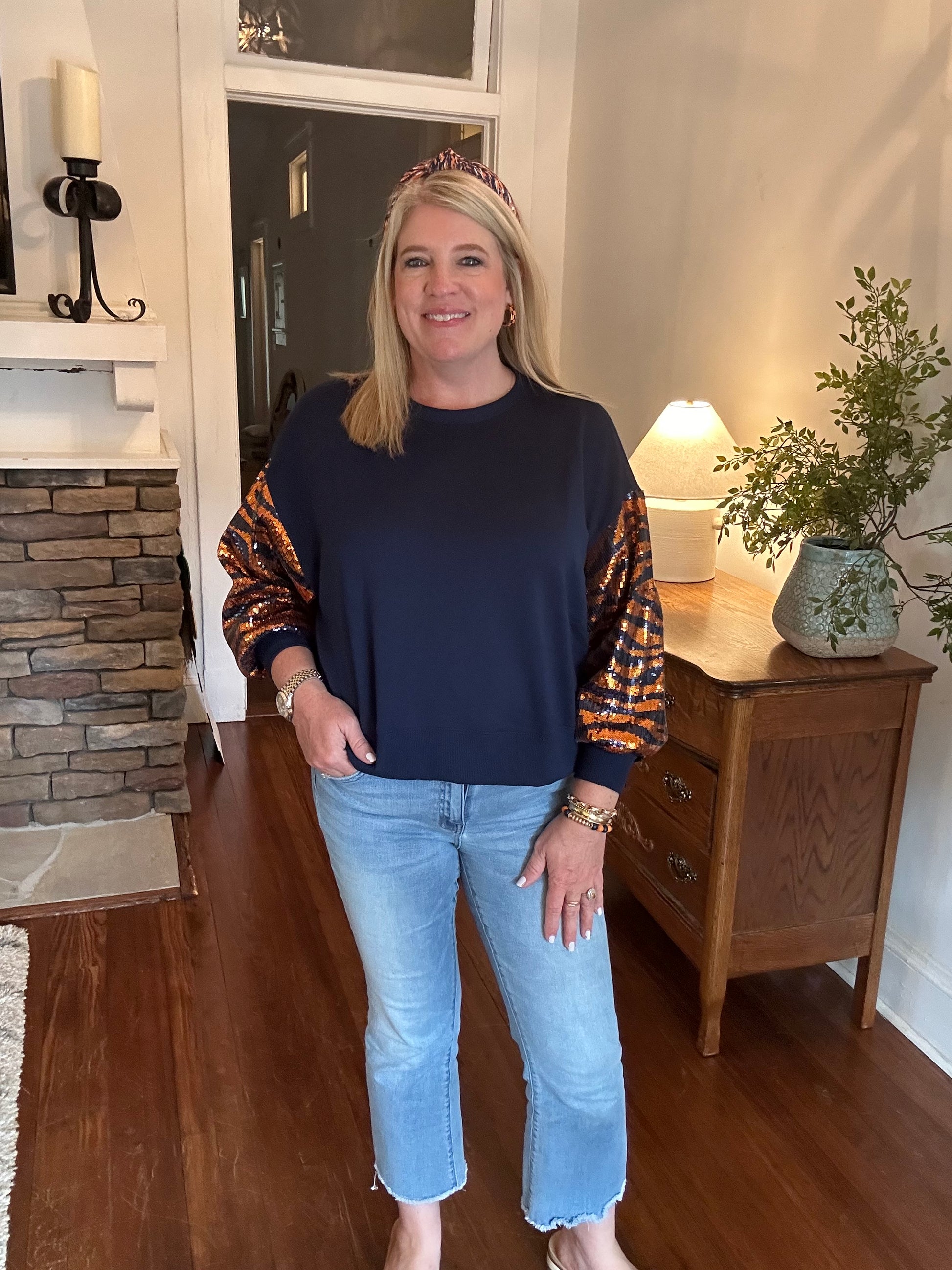 Navy sweatshirt with sequin sleeves in orange tiger stripes