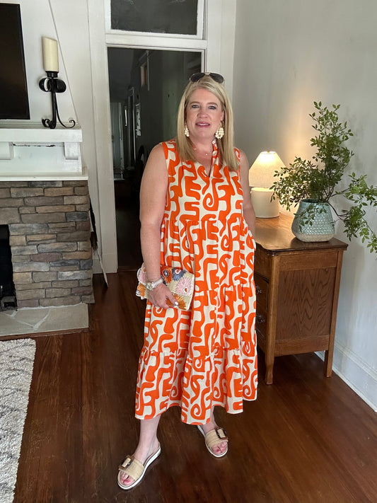 Mod print orange and white sleeveless, midi dress with pockets