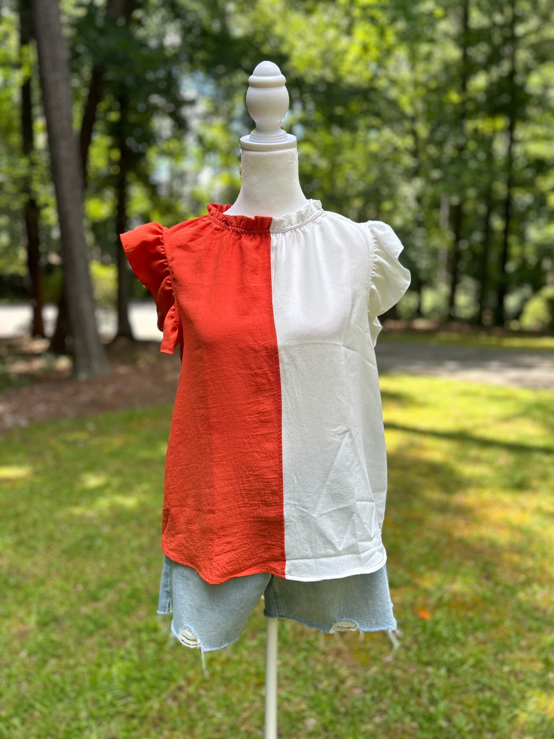 Orange and white colorblock top with ruffle sleeve and neck