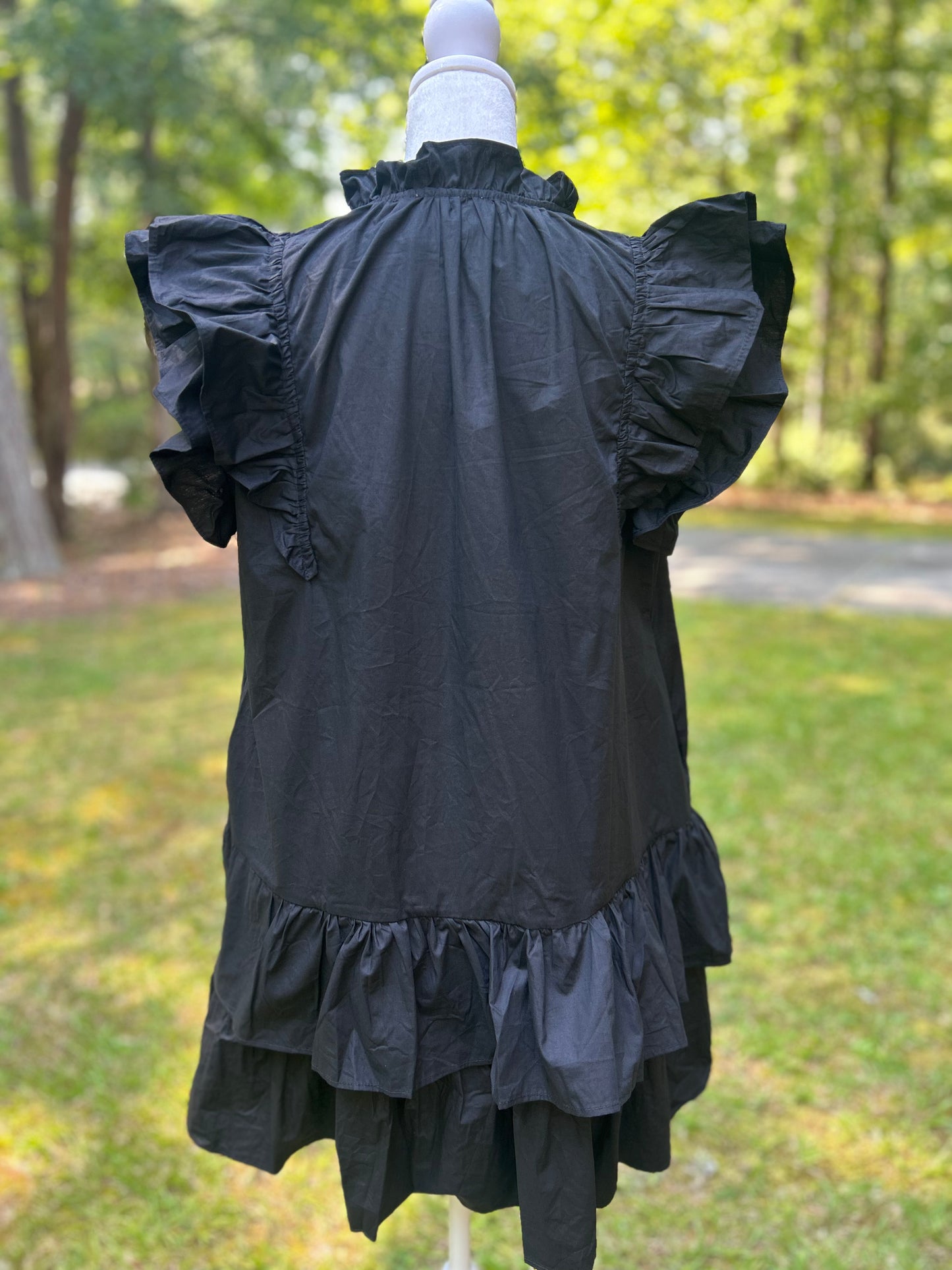 Ruffled black dress with red sequin stars