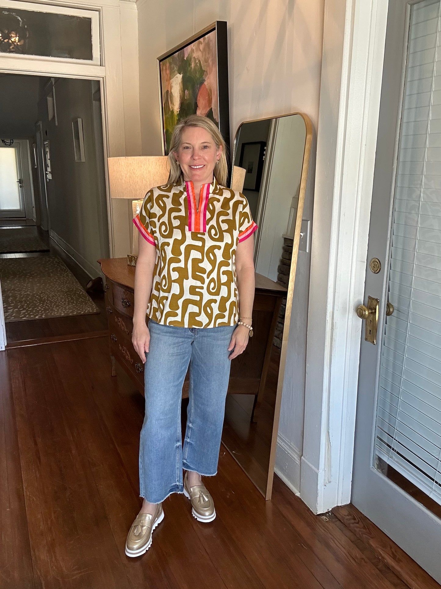 THML abstract print top in mustard green and cream with pink and orange striped details on the cuff and collar. 