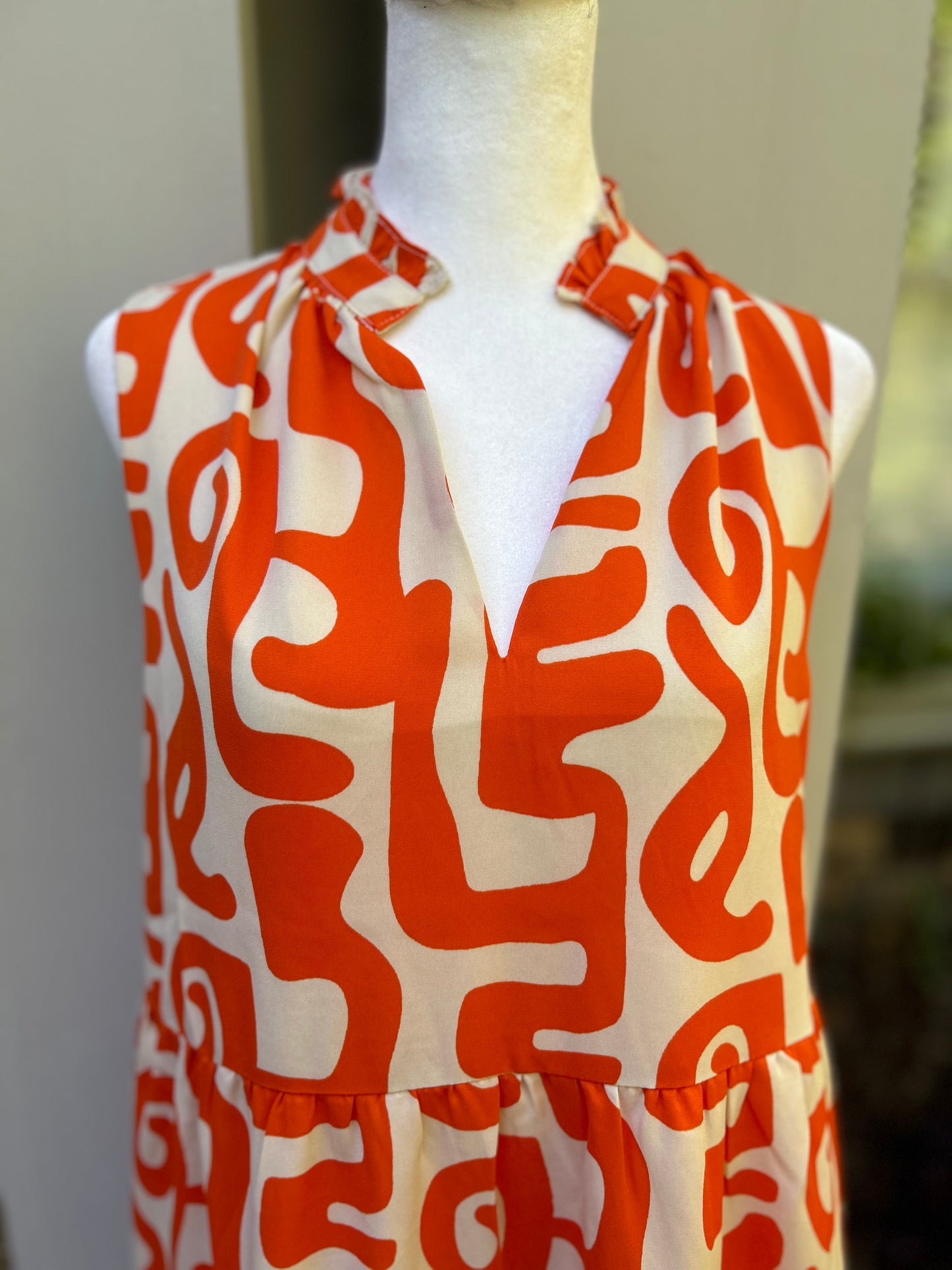 THML mod dress in orange and white with v-neck, ruffled neckline and pockets 