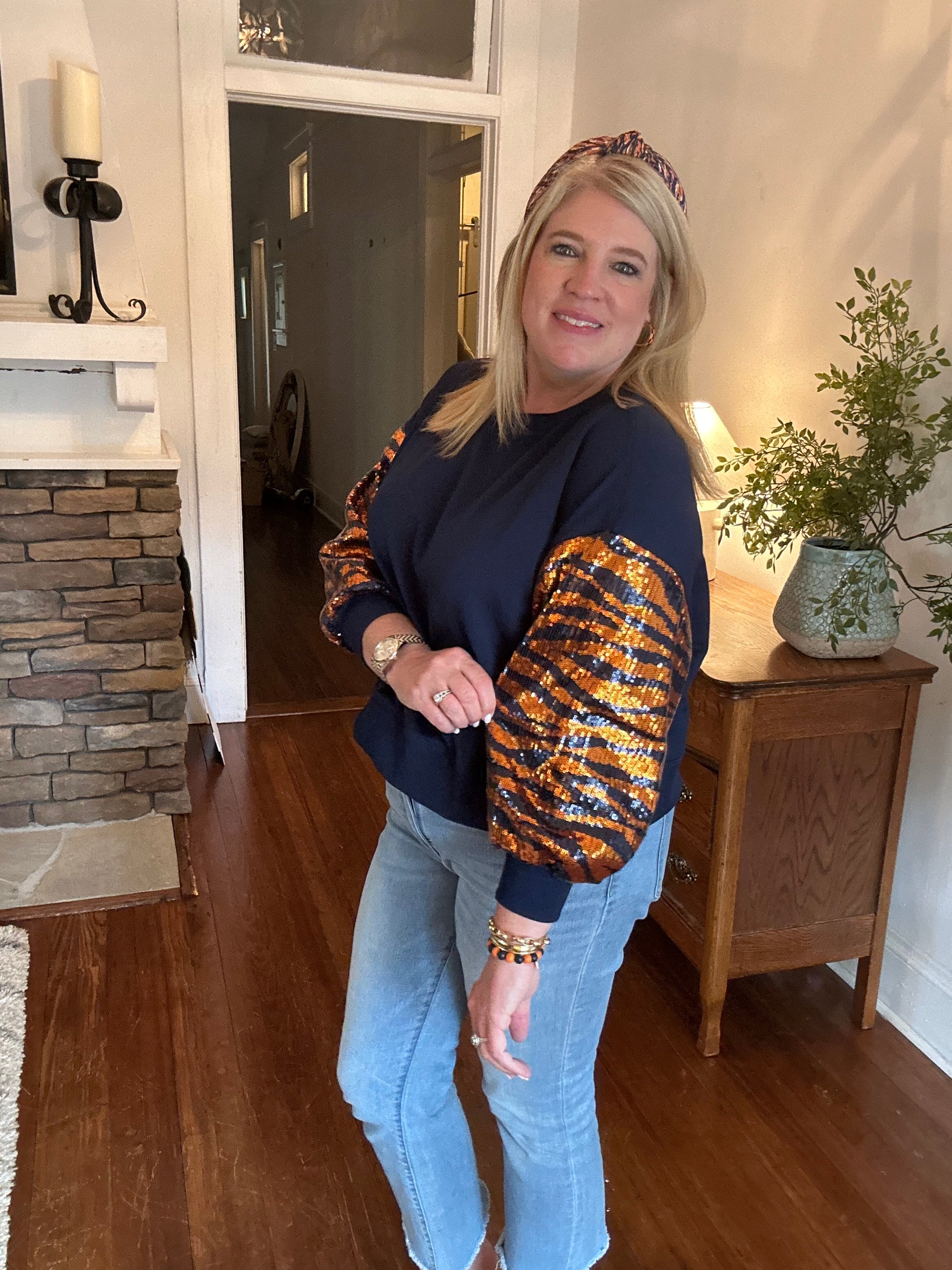 Tiger stripes on the sleeves and a navy sweatshirt