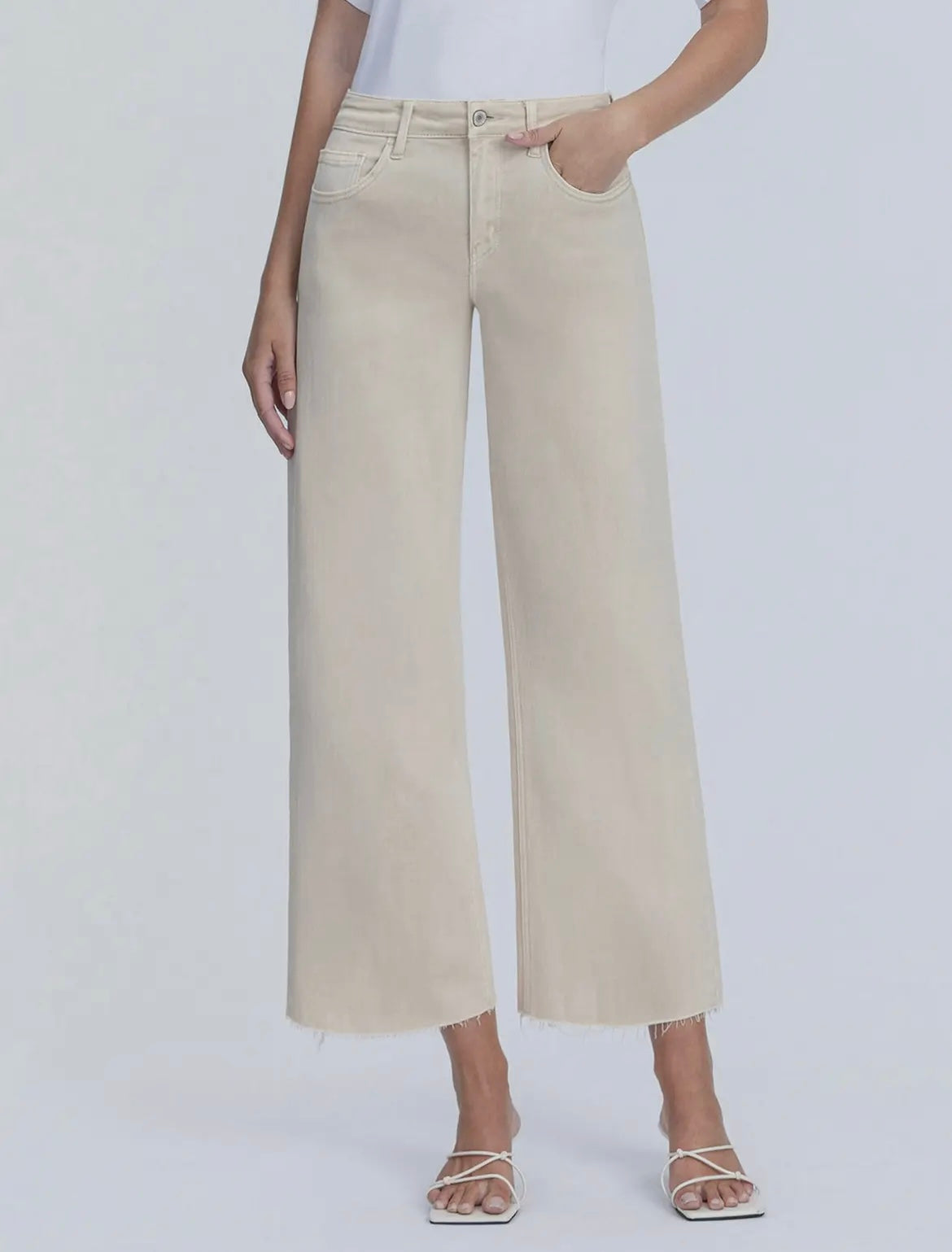 Beige wide-leg pants worn by a person on a white background