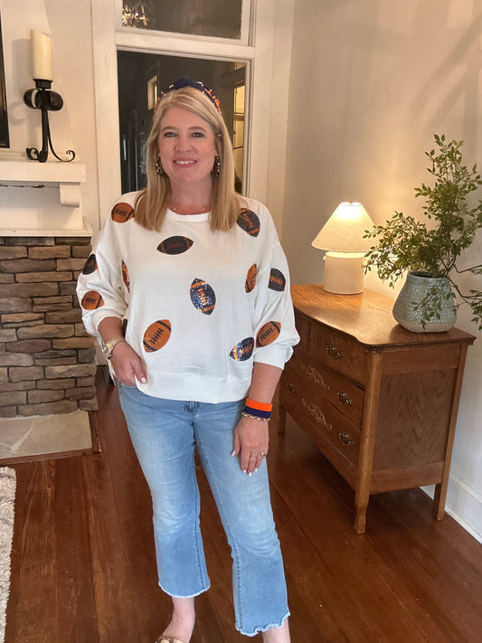 Gameday sweatshirt in white with navy and  orange sequin footballs. 