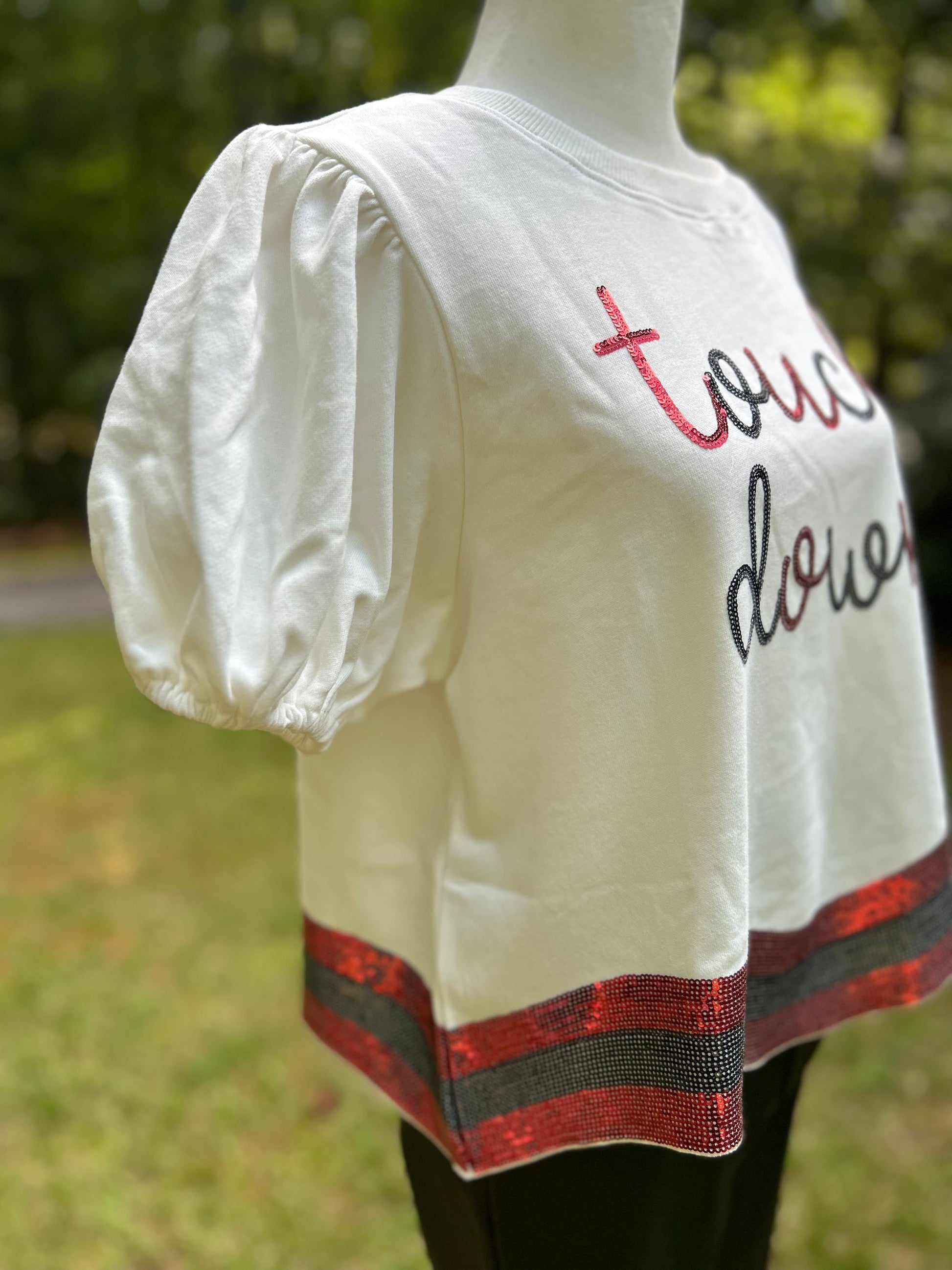 White puff sleeve detail on Touch down top