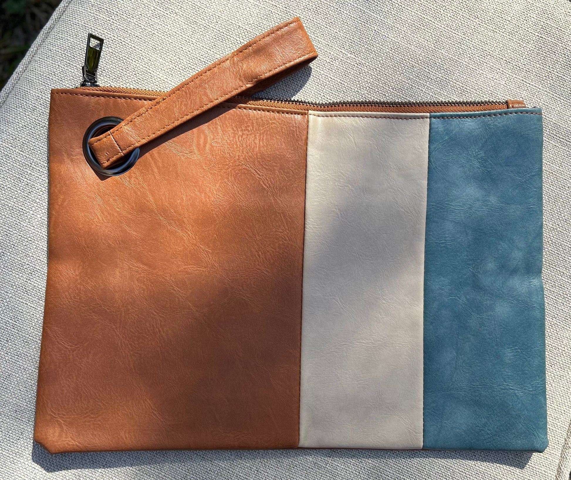 tan and blue clutch